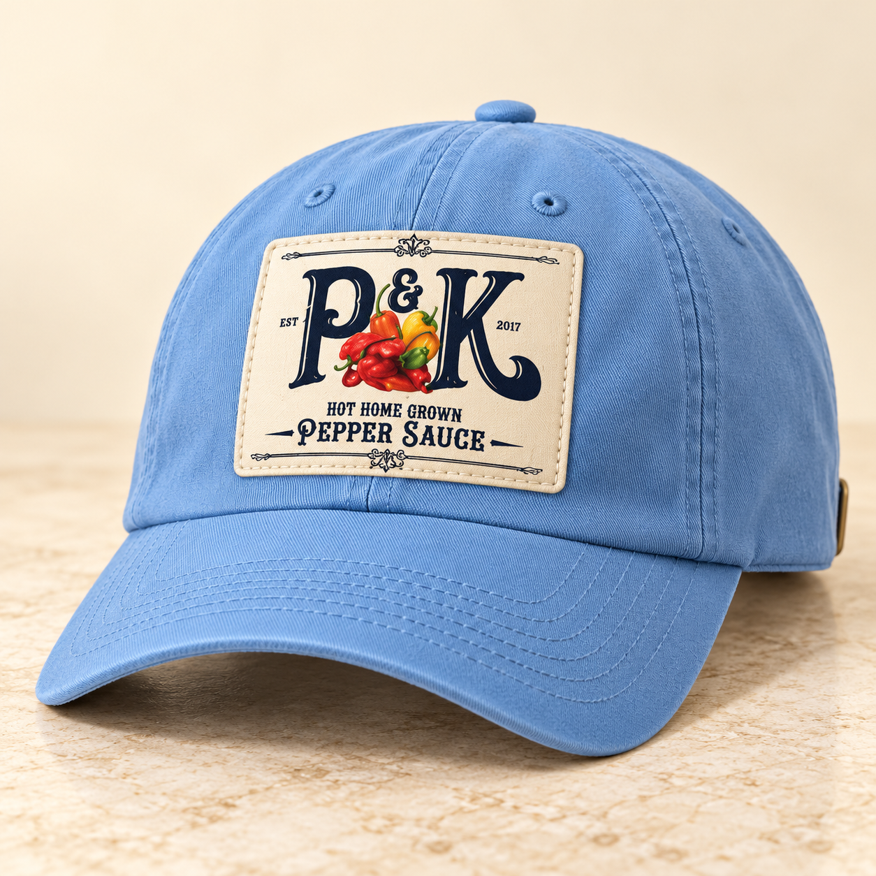 Light-blue baseball cap concept with a P&K Pepper Sauce print on the front